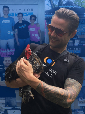 a man holding a rooster